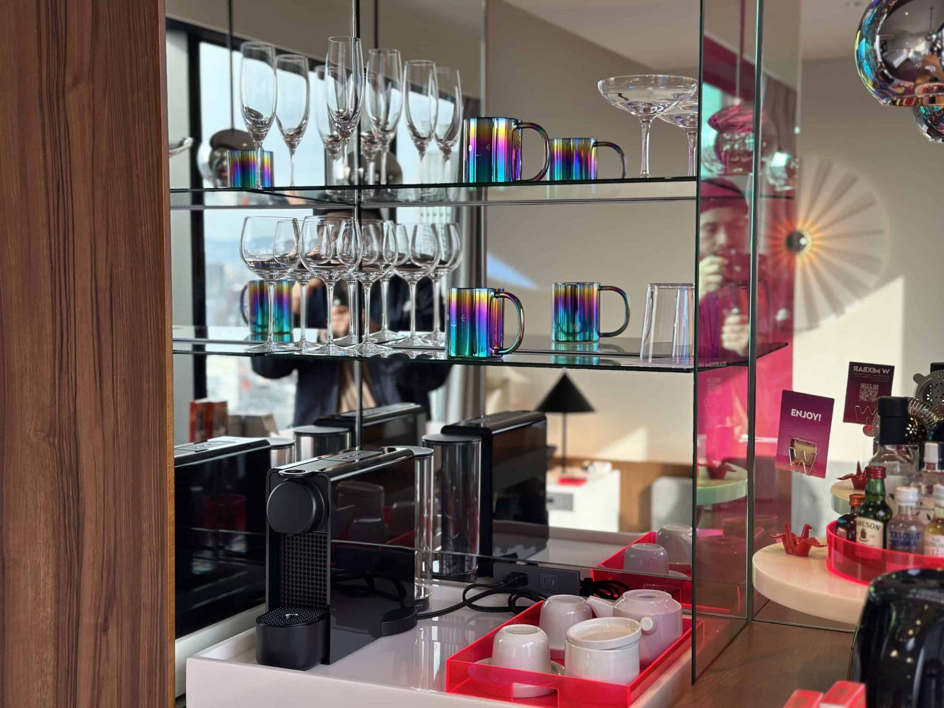 Nespresso machine, coffee mugs, and wine glasses.