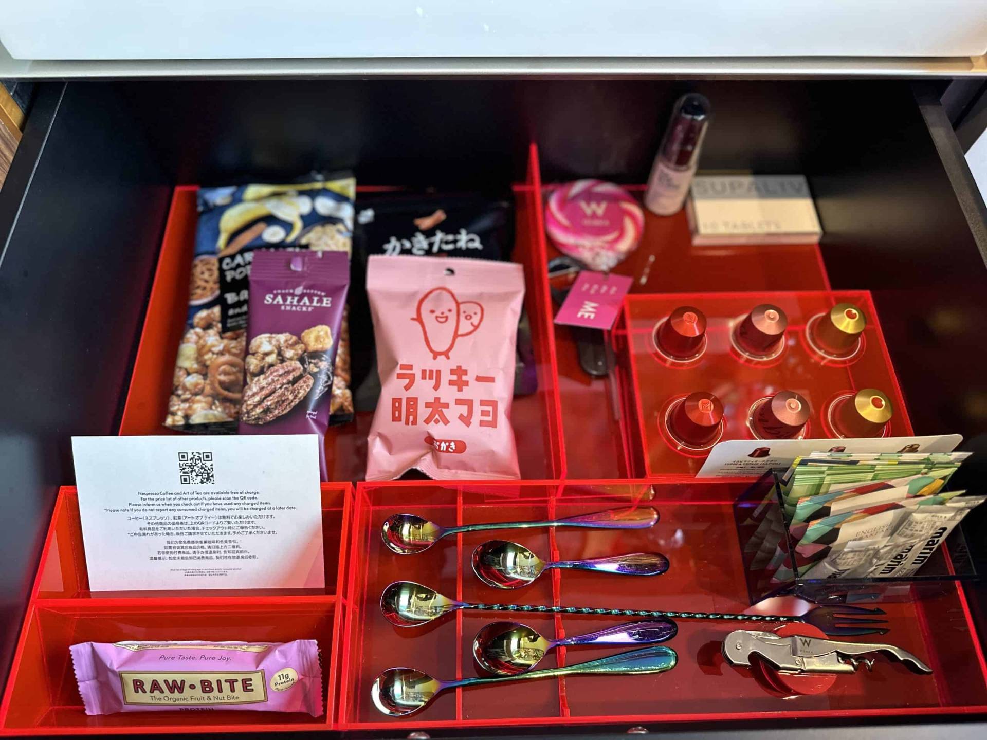 Pull out drawer with nespresso pods, tea, candy, and snacks.