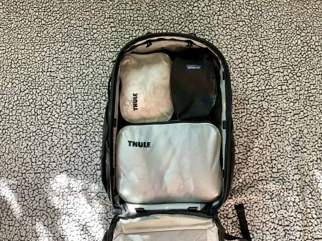 Packing cubes fit snug in a travel backpack and reduce overall volume.